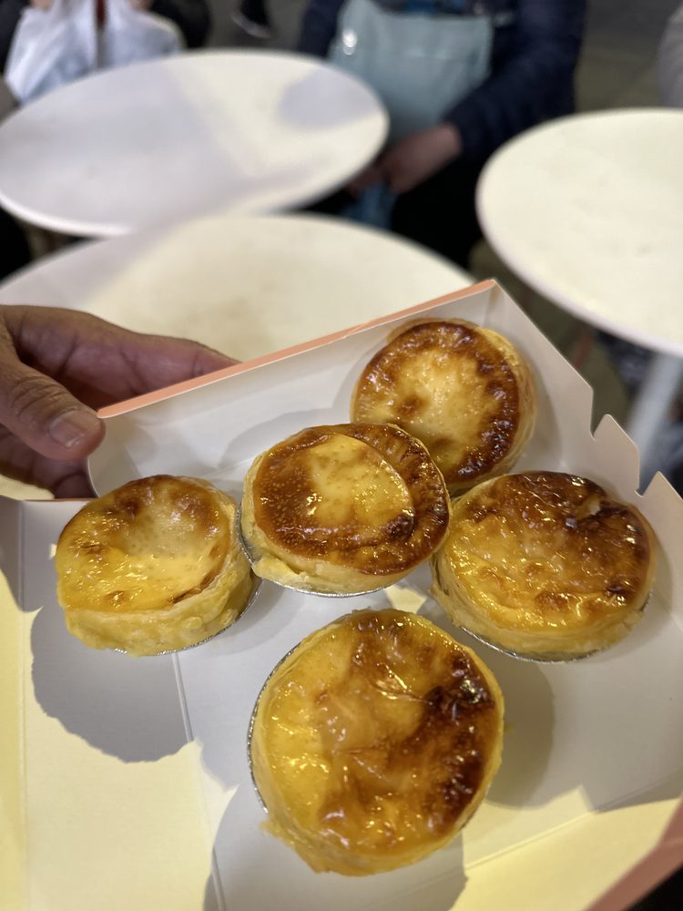 A box of fresh egg tarts from a Chinatown bakery