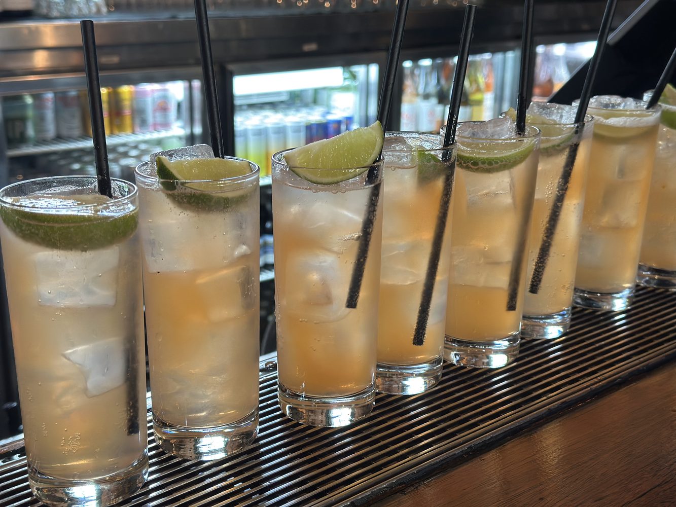 Row of house cocktails with lime garnish at a Surry Hills bar