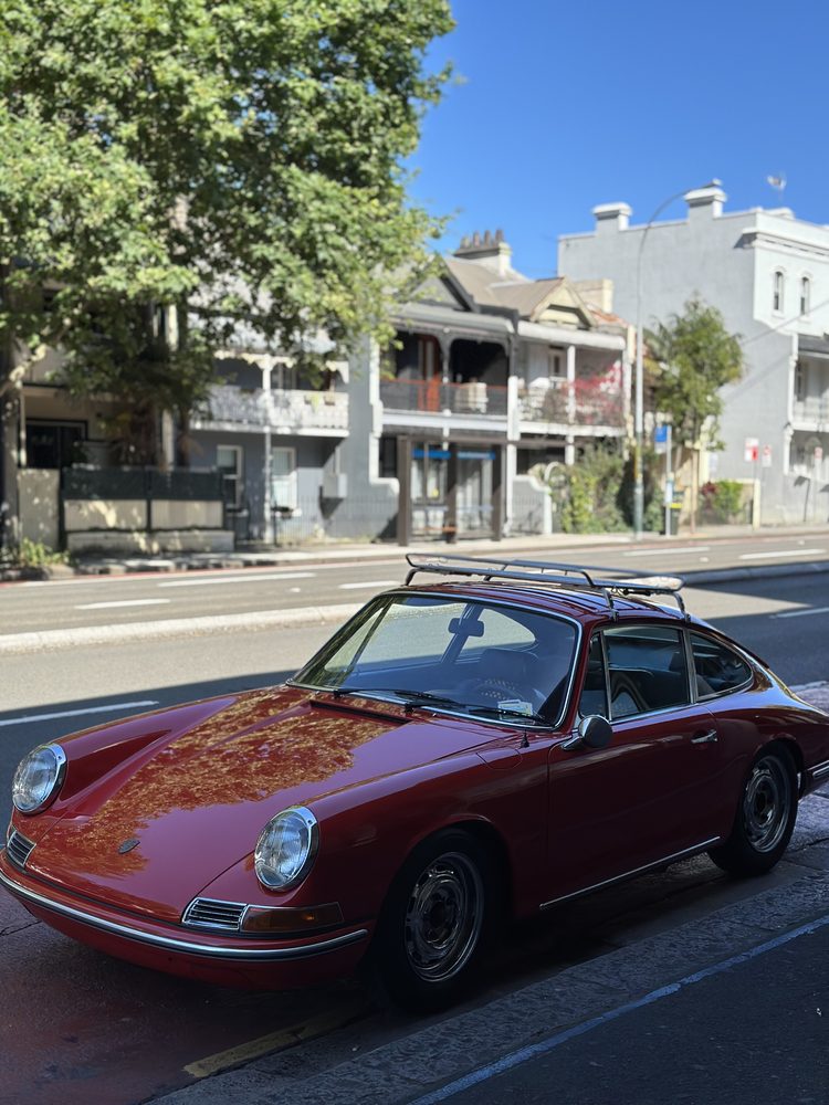 A classic car parked on a leafy Surry Hills street