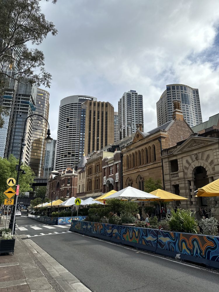 Historic sandstone buildings against the Sydney city skyline