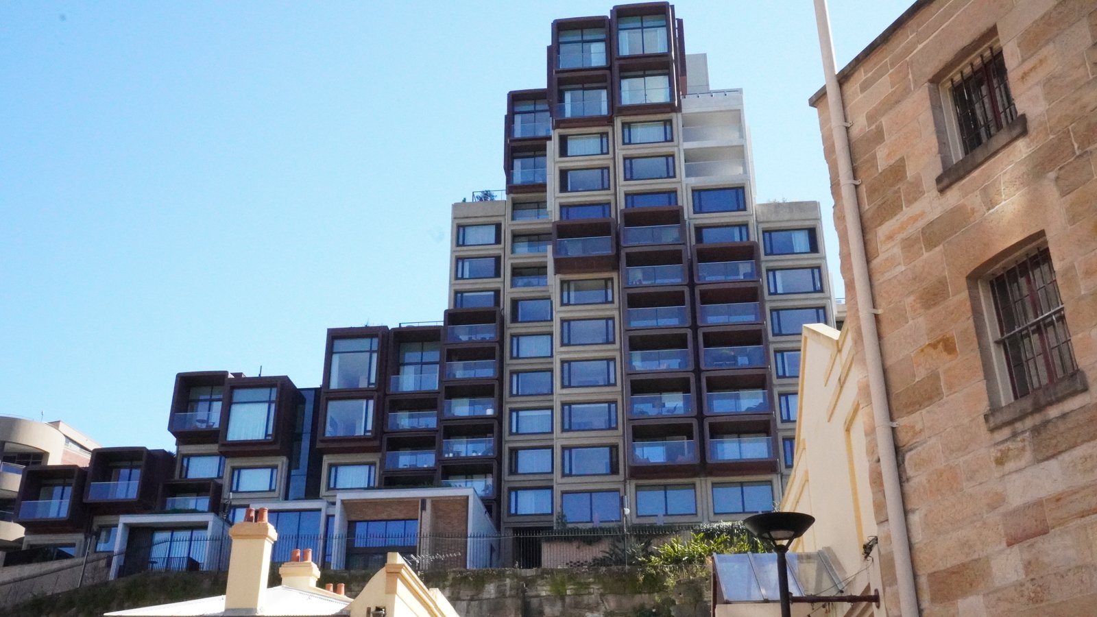 Modern apartments rising above The Rocks' sandstone terraces